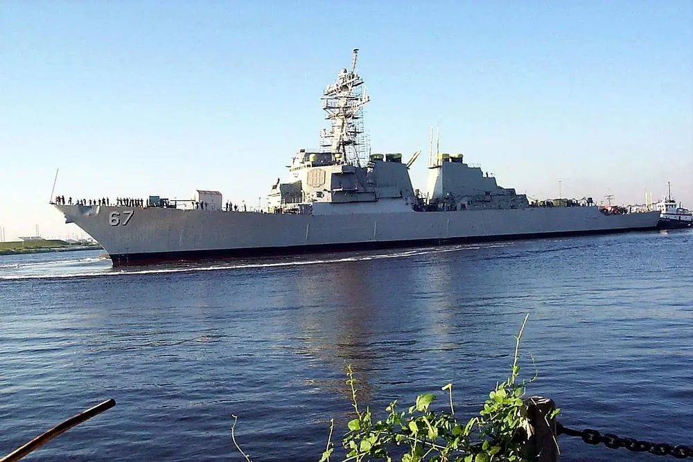 The destroyer USS Cole, hull number 67, under way with crew lining the rail