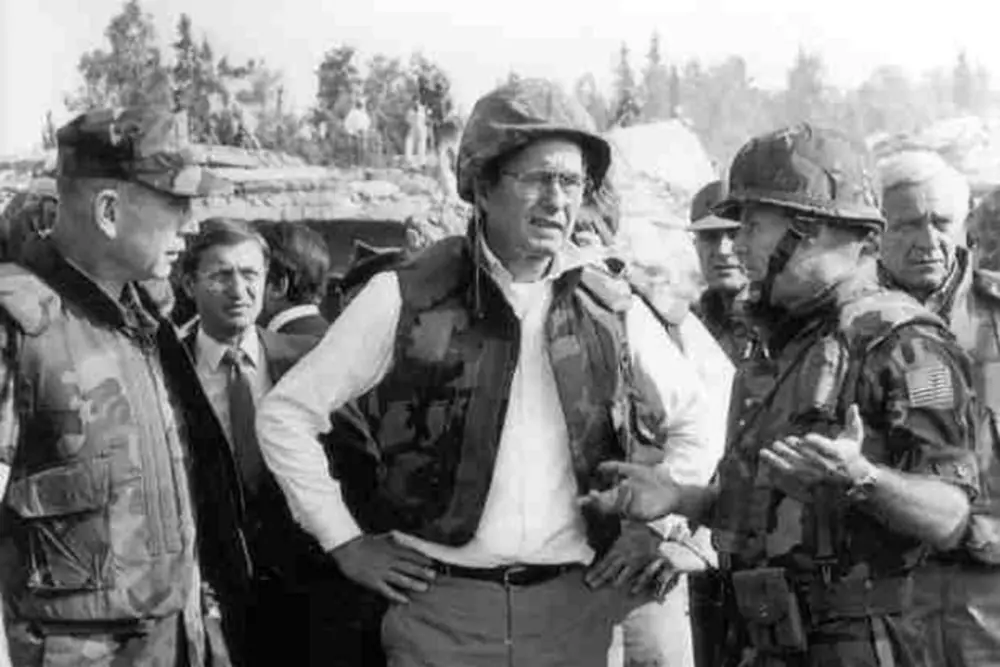 Marine Gen. P.X. Kelley and Col. Tim Geraghty walking Vice President George H.W. Bush around the bombed barracks site